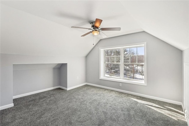 bonus room featuring lofted ceiling, ceiling fan, and dark colored carpet