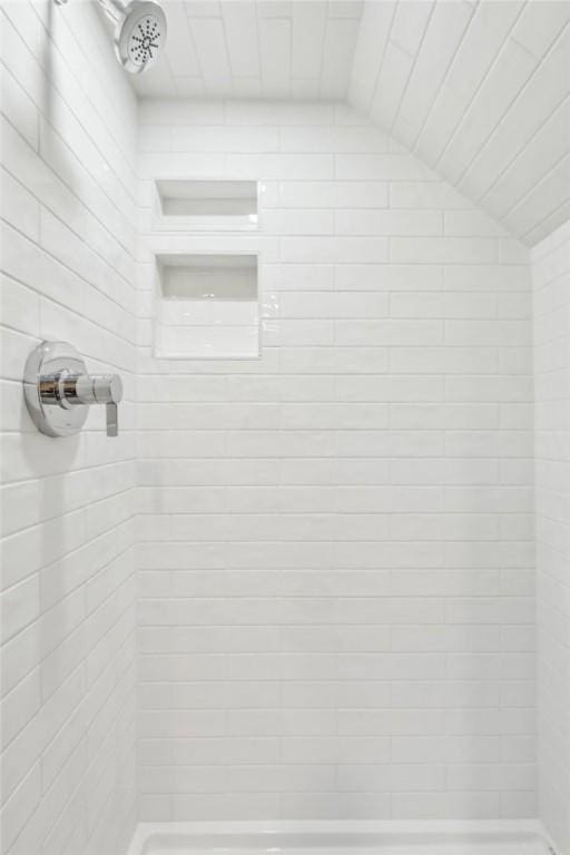 bathroom with a tile shower