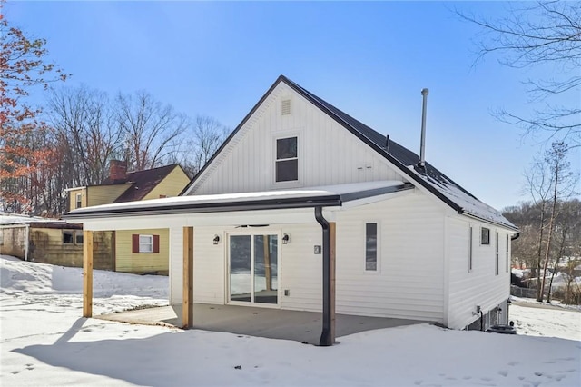 view of snow covered rear of property