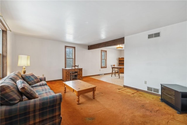 living room with beamed ceiling and carpet