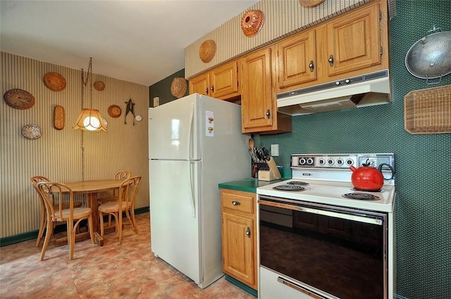 kitchen featuring wallpapered walls, white appliances, decorative light fixtures, and under cabinet range hood