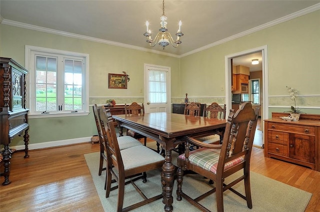 1722 Arlington Rd, Blackridge, PA 15235 - dining area with light wood-type flooring, crown molding, and an inviting chandelier