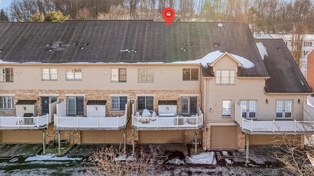 view of snow covered back of property