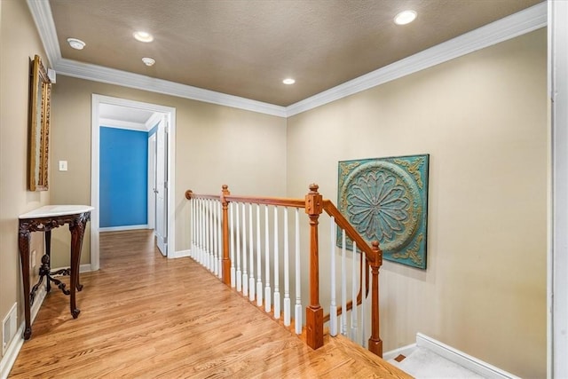 hall featuring ornamental molding and light hardwood / wood-style floors