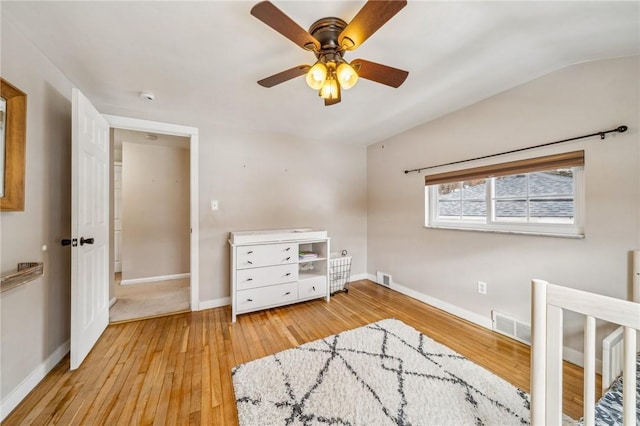 bedroom featuring vaulted ceiling, light wood-type flooring, and ceiling fan