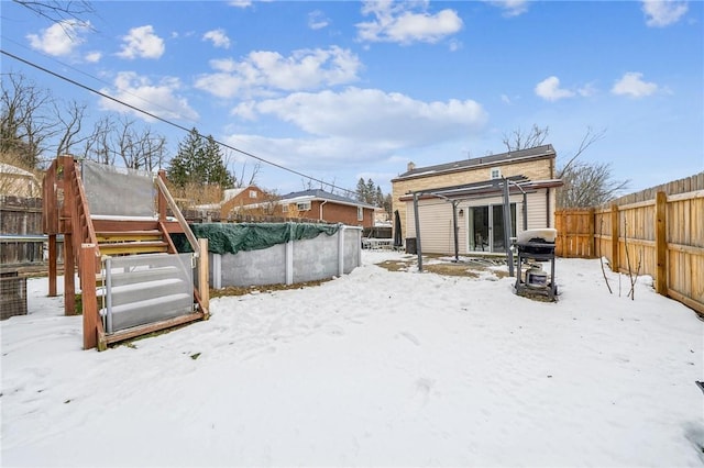 yard covered in snow featuring a covered pool