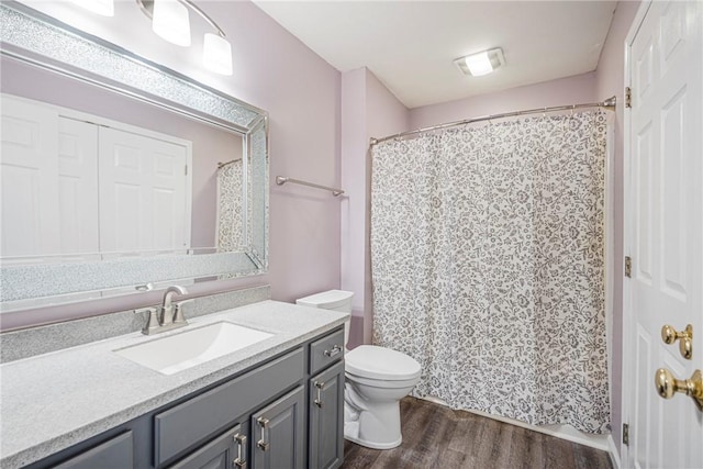 bathroom with vanity, hardwood / wood-style floors, and toilet