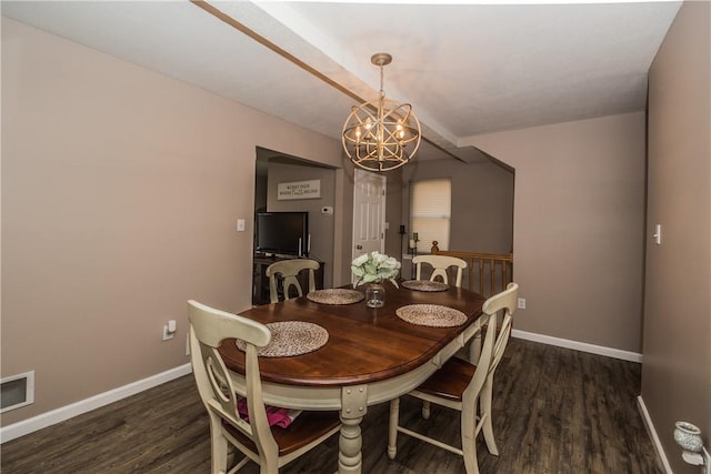 dining space with dark wood-type flooring and a chandelier