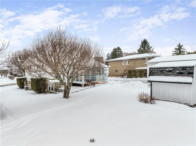 view of yard layered in snow