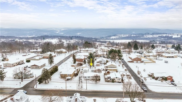 snowy aerial view with a mountain view