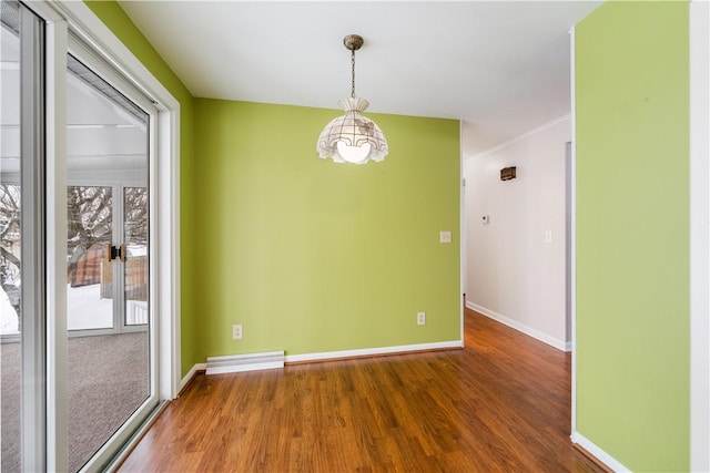 unfurnished room featuring an inviting chandelier and hardwood / wood-style floors