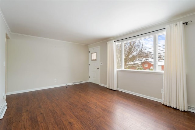 spare room with crown molding and dark wood-type flooring