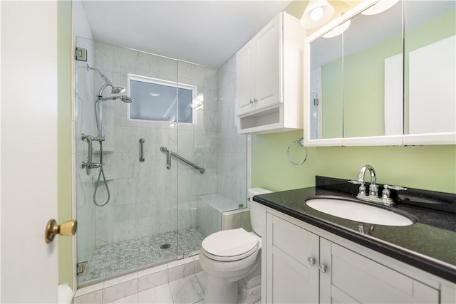 bathroom with vanity, toilet, and a shower with shower door