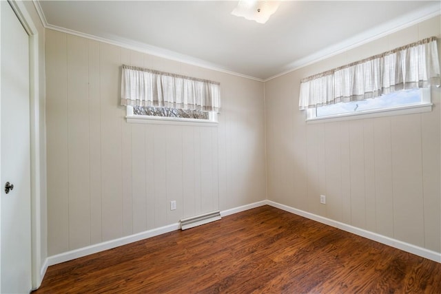 spare room featuring dark wood-type flooring and crown molding