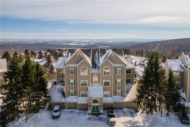 snowy aerial view featuring a mountain view