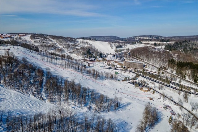 snowy aerial view featuring a mountain view