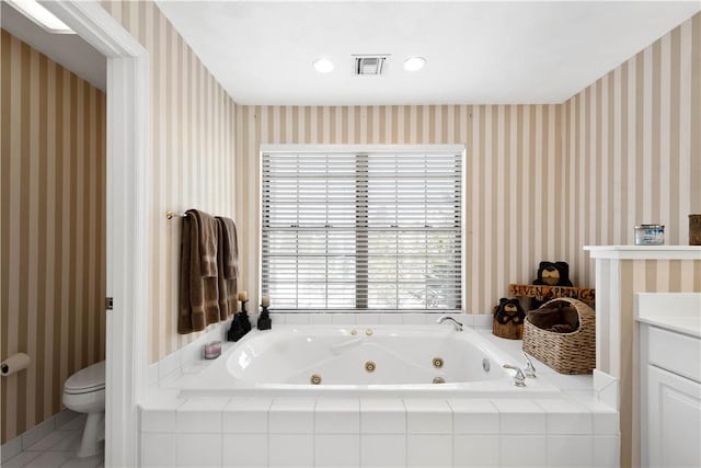 bathroom featuring vanity, tiled tub, tile patterned floors, and toilet