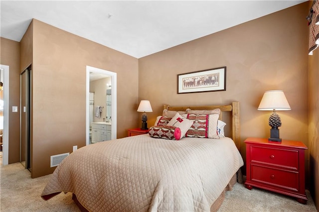 carpeted bedroom with ensuite bathroom