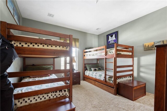 bedroom featuring light carpet