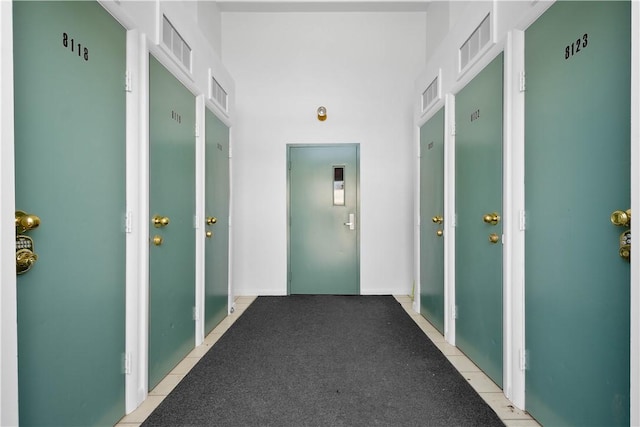 hall with light tile patterned floors