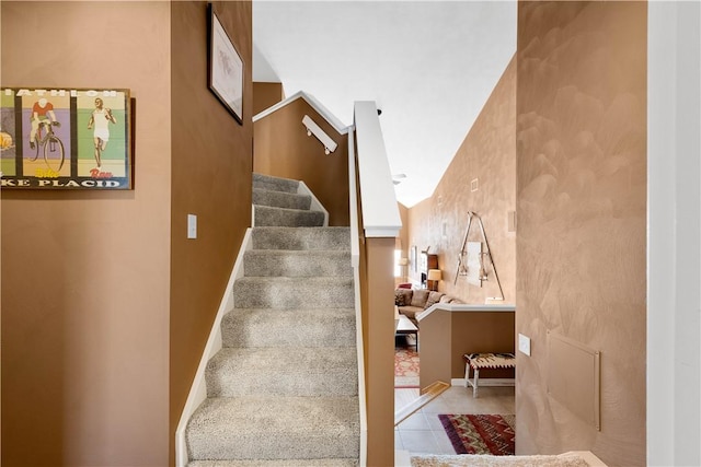 stairs with tile patterned flooring