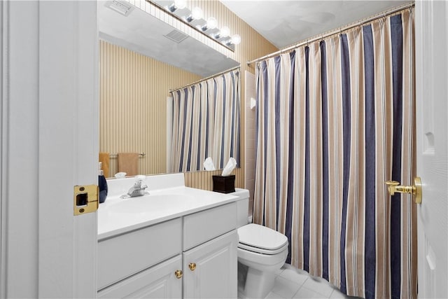 bathroom with vanity, walk in shower, tile patterned floors, and toilet