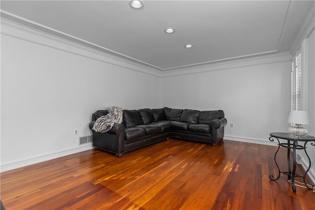 living room with dark wood-type flooring and ornamental molding