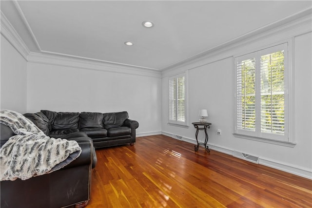 living room featuring crown molding and hardwood / wood-style flooring