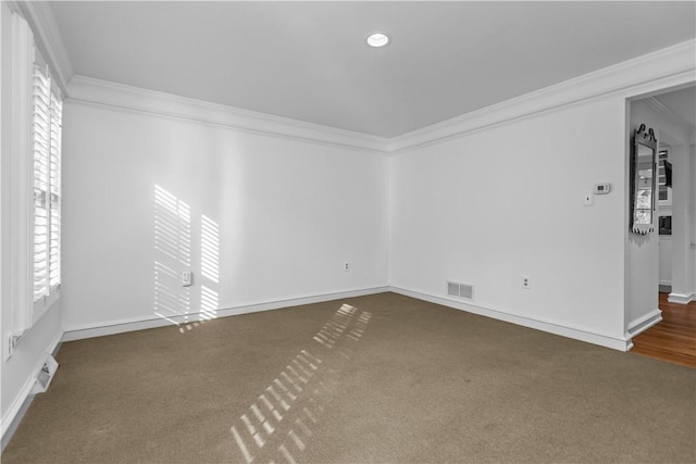 carpeted empty room featuring ornamental molding