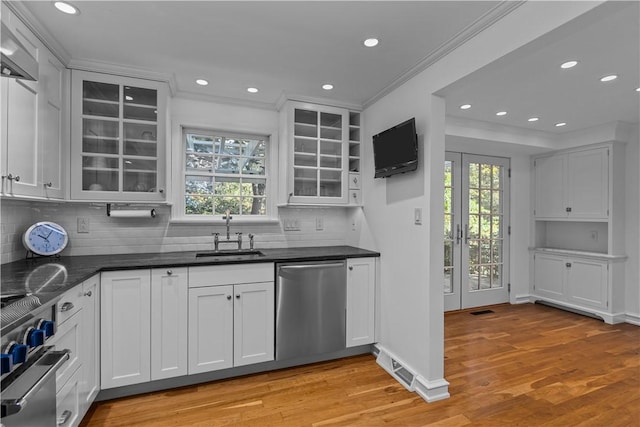 kitchen with ornamental molding, appliances with stainless steel finishes, sink, and white cabinets