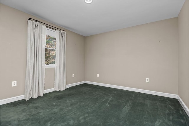 spare room with dark colored carpet