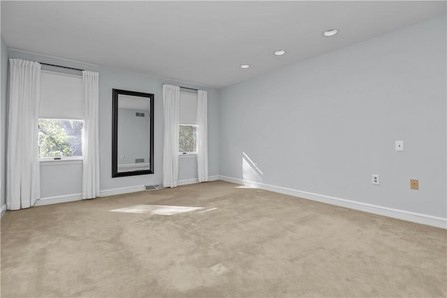 unfurnished room with light carpet