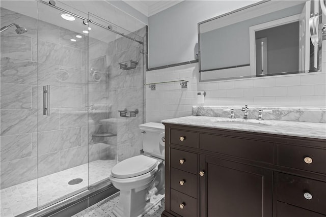 bathroom featuring crown molding, tile walls, vanity, a shower with shower door, and toilet