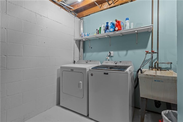 washroom with washer and clothes dryer and sink