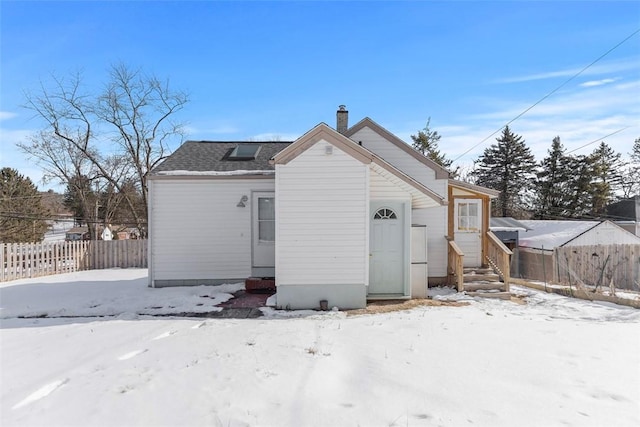 view of snow covered rear of property