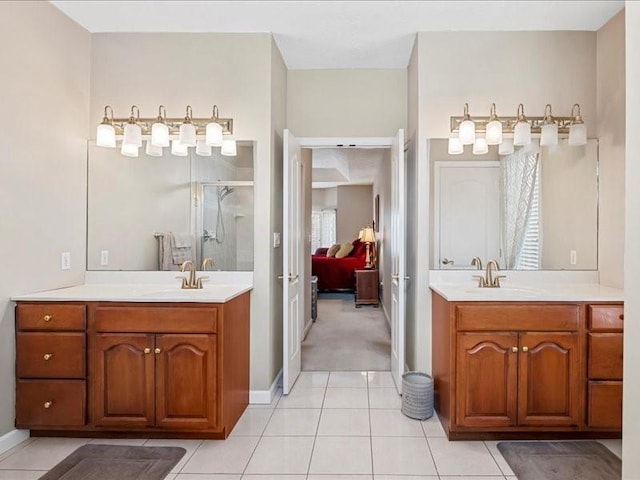 bathroom with tile patterned flooring, vanity, and an enclosed shower