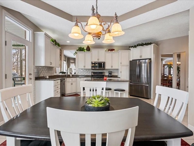 dining space with an inviting chandelier