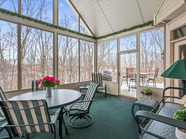 sunroom / solarium featuring lofted ceiling