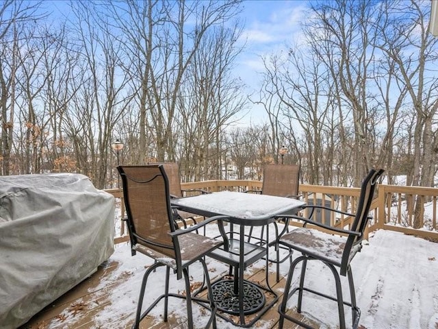 snow covered deck with grilling area