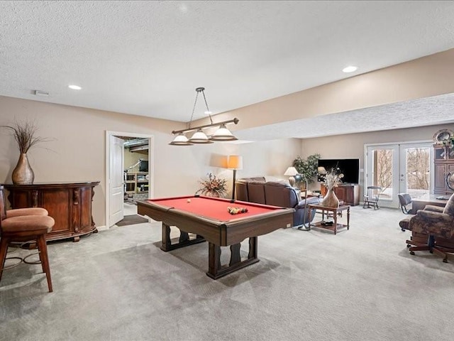 game room featuring billiards, light carpet, a textured ceiling, and french doors