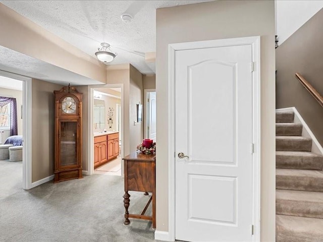 interior space with light colored carpet and a textured ceiling