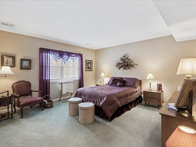 bedroom featuring a textured ceiling and carpet