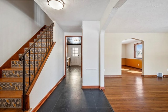 foyer entrance featuring dark hardwood / wood-style flooring and a healthy amount of sunlight