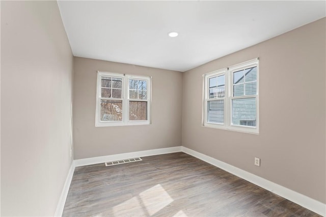 unfurnished room with wood-type flooring and plenty of natural light