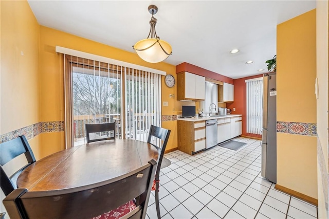 dining space featuring light tile patterned flooring and sink