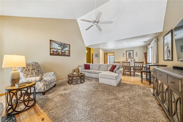 living room featuring ceiling fan, wood-type flooring, and high vaulted ceiling