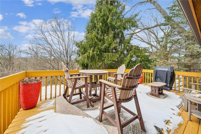 snow covered deck featuring grilling area