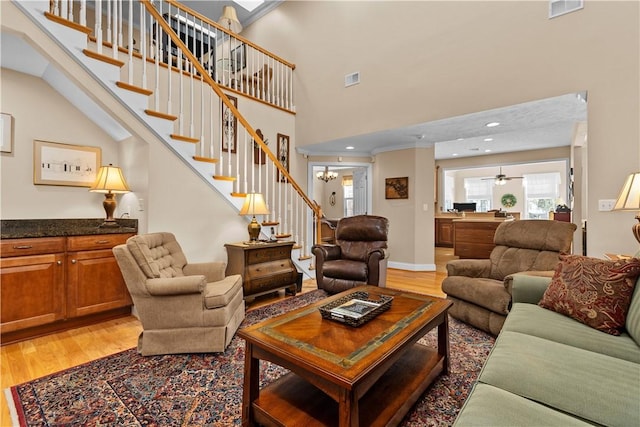 living room with hardwood / wood-style floors and a high ceiling