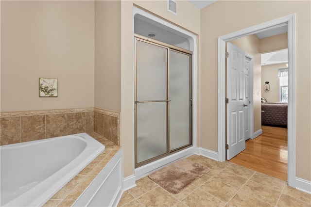 bathroom with tile patterned floors and plus walk in shower