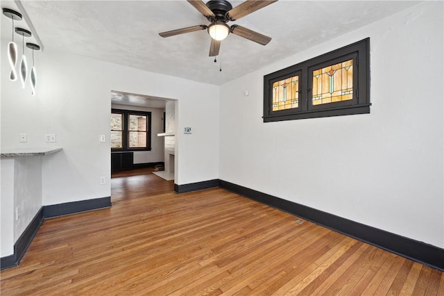 empty room featuring wood-type flooring and ceiling fan